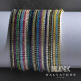 Pulseras de colores variados con brillantes de cristal, presentadas sobre un fondo blanco. Diseñadas por Blink Salvatore Plata, ideales para complementar cualquier atuendo.